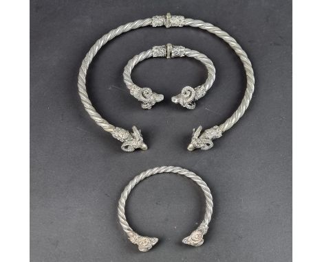 A vintage Greek white metal Ram's head hinged bangle, the three dimensional Ram's heads having finely cast detail connected b