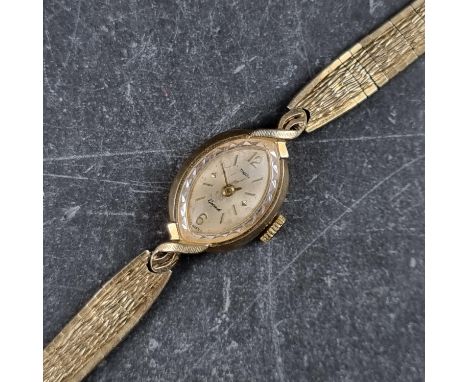 A vintage Swiss yellow metal manual wind ladies wristwatch, stamped 14k, 14mm, on gold plated bracelet.