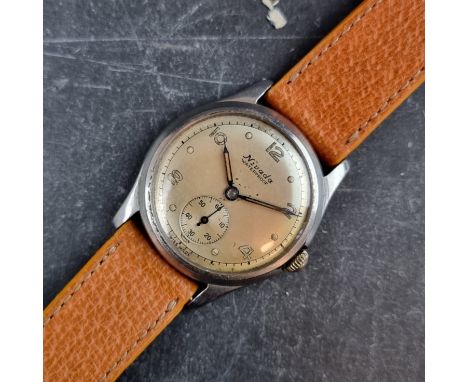 A late 1940s military style Nivada Grenchen stainless steel manual wind wristwatch, 33mm, Ref. 257459, on later leather strap