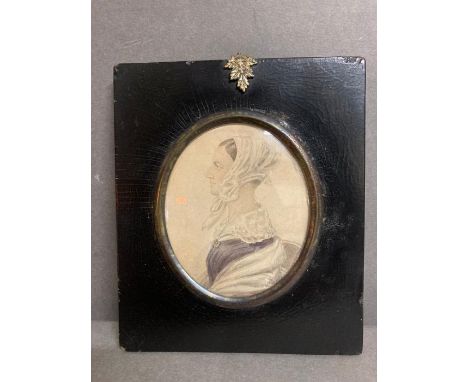 A framed miniature portrait of a llady with white lace collar and bonnet with description verso and a link to Chaten House
