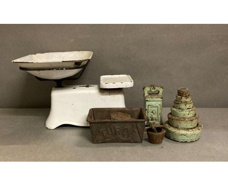 A set of vintage cream enamel kitchen scales and a selection of weights and a set of three vintage measuring cups 