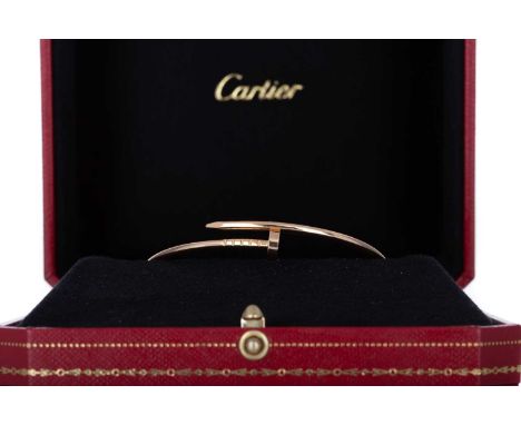 CARTIER, JUSTE UN CLOU BANGLE  small model, size 17, numbered KBO334, in eighteen carat rose gold, lacking papers  Lightly wo