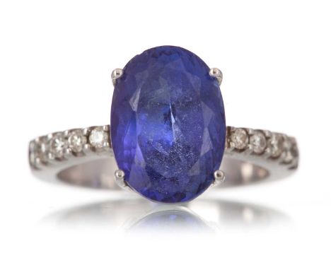 TANZANITE AND DIAMOND RING, set with an oval tanzanite of approximately 5.99 carats, on diamond shoulders totalling approxima