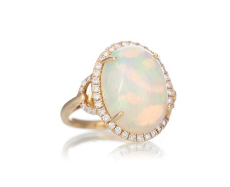 OPAL AND DIAMOND RING, set with a cabochon opal within a halo of diamonds, in eighteen carat gold, size K 1/2Opal = 16.1x12.5