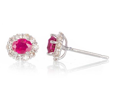 PAIR OF RUBY AND DIAMOND EARRINGS, set with central rubies within diamond halos totalling approximately 0.30 carats, in in ei