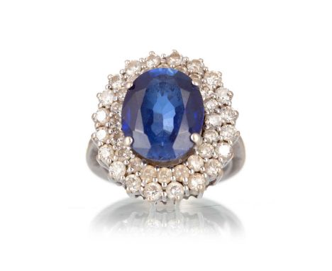 SAPPHIRE AND DIAMOND RING, set with an oval sapphire of approximately 7.13 carats, within a double diamond halo totalling app