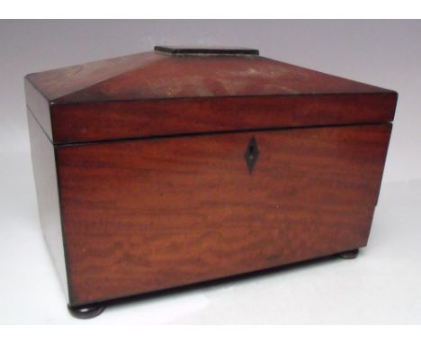 A 19TH CENTURY MAHOGANY SARCOPHAGUS SHAPED TEA CADDY, the hinged lid opening to a part fitted interior with twin tea canister
