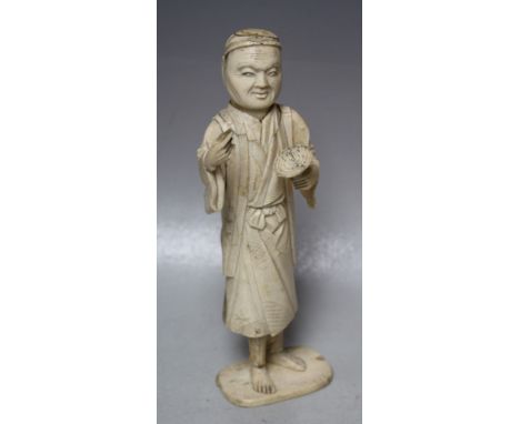 A JAPANESE CARVED IVORY OKIMONO, depicting an artist / scholar, the right hand with a missing implement, Meiji period, H 20 c