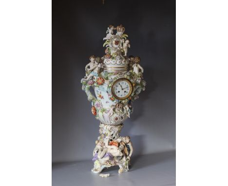 A LARGE AND IMPOSING CONTINENTAL CERAMIC TABLE CENTREPIECE LIDDED CLOCK URN, with typical figurative cherubic Putti embellish