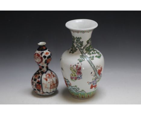 A CHINESE VASE FEATURING CHILDREN PLAYING, H 26 cm, together with a small Japanese Imari style double gourd, (2)