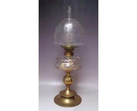 A 19TH CENTURY BRASS AND GLASS OIL LAMP, with circular and bulbous support leading to a cleat glass reservoir, etched glass s