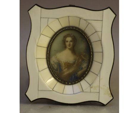 BAUER (XX). An oval portrait miniature on ivorine of a young woman in elegant dress, signed middle left, framed and glazed, 7