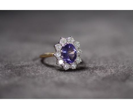 AN 18CT YELLOW GOLD TANZANITE AND DIAMOND CLUSTER RING, Oval-cut tanzanite 2.46ct. RBC diamonds 1.50ct , Ring size P 1/2