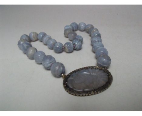 A LAVENDER JADE CARVED PANEL AND BEAD NECKLACE, the individual beads approx Dia. 1.5 cm with carved decoration, having centra