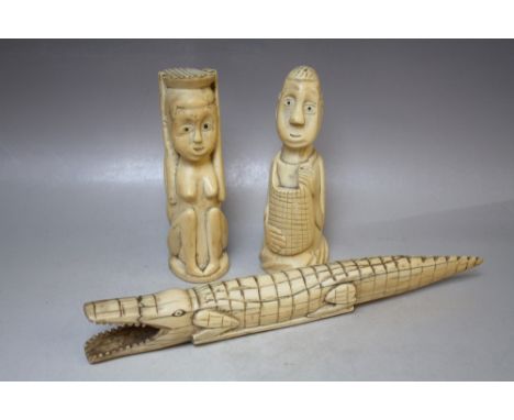 A PAIR OF EARLY 20TH CENTURY CARVED IVORY TRIBAL HEADS, together with an ivory carved crocodile, L 34 cm, S/DCondition Report