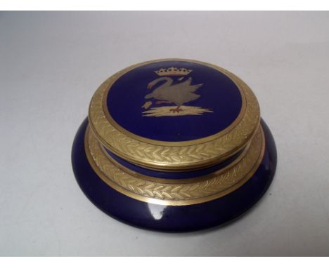 A CONTINENTAL CIRCULAR CERAMIC LIDDED POT, blue ground, with gilded border, armorial style crest to lid depicting a goose sho