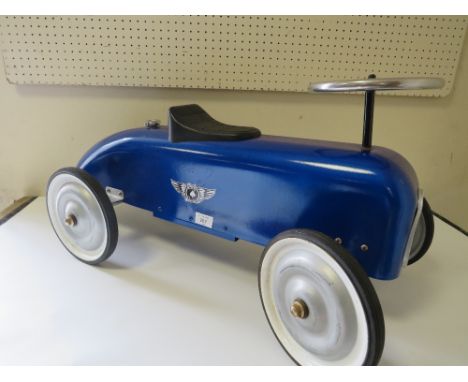 A CHILDRENS VINTAGE STYLE RIDE ON BLUE RACING CAR
