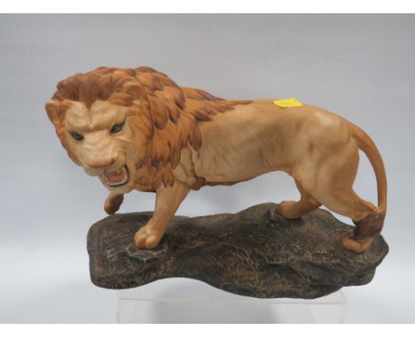 A BESWICK LION ON A ROCK