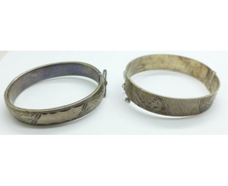 A silver wax filled bangle and one other silver bangle, 68g 