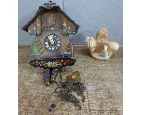 A cuckoo clock with weights and a Sylvac posy vase 