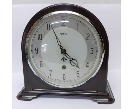 A Smiths Bakelite mantel clock with broad arrow on the dial 