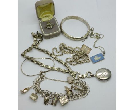 A collection of silver jewellery including a bangle, charm bracelet, locket on chain and marcasite ring 