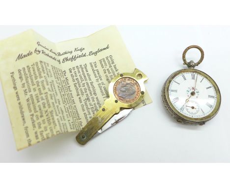 An .800 silver fob watch and a novelty pocket knife inset with a farthing coin, with box and leaflet 