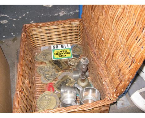 wicker hamper containing various brass plaques and some pewter ware 