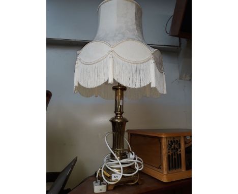 A brass base table lamp and shade 