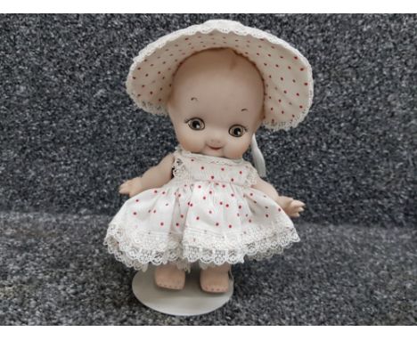 A vintage bisque doll with articulated arms, inscribed P/B #6 '85, 18cm high.