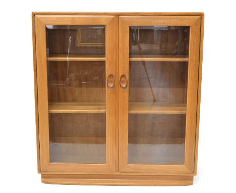 Ercol elm Windsor glazed bookcase Ercol elm Windsor glazed bookcase or display cabinet, model 810, two glazed doors enclosing