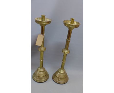 A pair of 19th century brass floor standing candlestick holders. H-80cm