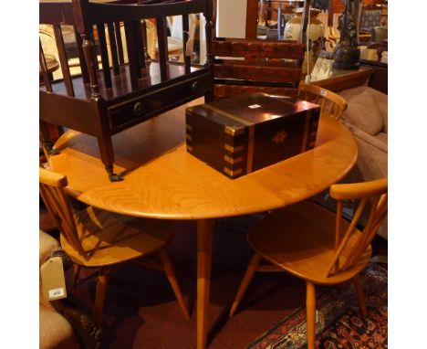 A set of four Ercol candlestick back chairs with cross double stretchers, raised on tapered legs.
