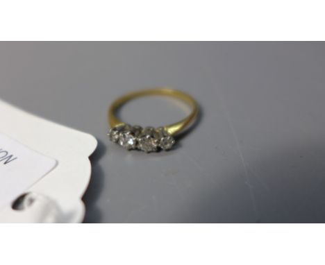 A ladies 18ct gold ring having four brilliant cut diamonds on a platinum mount.