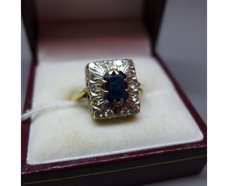 A ladies 18ct gold, diamond and sapphire dress ring, central oval cut sapphire with diamond surround