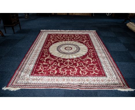 A Large Woven Silk Carpet Abusson rug with red ground and with traditional floral and foliate border detail with central sunb