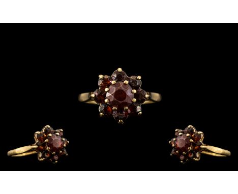 9ct Gold Garnet Set Ring, with a flower head design.  Ring Size L.  