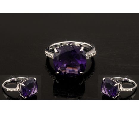 Amethyst Solitaire Ring, the 9ct square cushion cut amethyst, of a rich Royal purple colour, measures 14mm x 14, accented by 