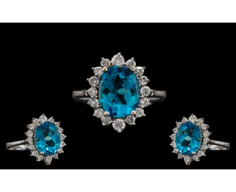 18ct White Gold - Attractive and Quality Blue Topaz and Diamond Set Cluster Ring. The Central Blue Topaz Surrounded by 16 Bri