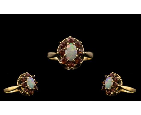 Ladies 9ct Gold - Attractive Ruby and Opal Set Ring, Flower head Setting. Fully Hallmarked for 9.375. The Central Opal Surrou