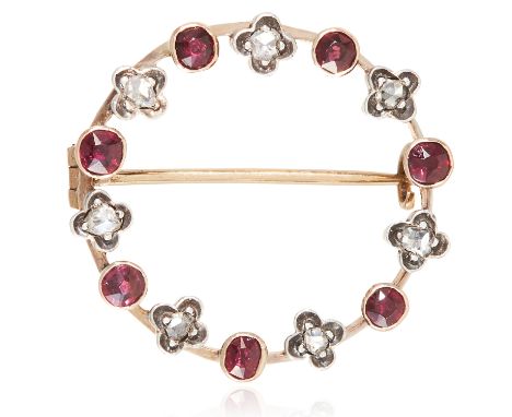 AN ANTIQUE RUBY AND DIAMOND BROOCH in yellow gold, in circular form, set with alternating rose cut diamonds and round cut rub