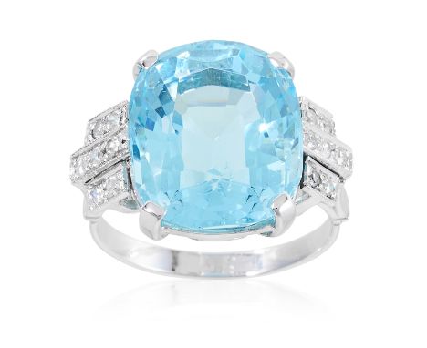 AN ART DECO AQUAMARINE AND DIAMOND RING in platinum or white gold, set with a cushion cut aquamarine of 12.41 carats between 