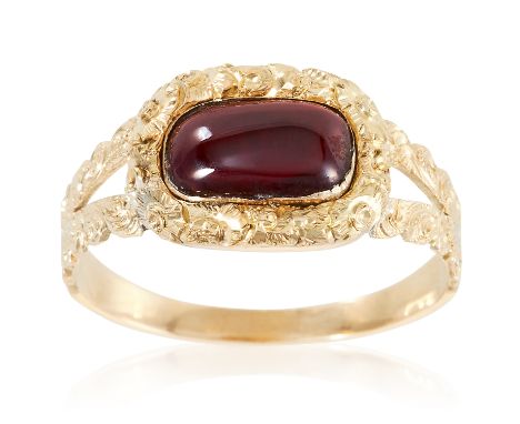 AN ANTIQUE GEORGIAN GARNET RING, EARLY 19TH CENTURY in high carat yellow gold, the oval cabochon garnet within a high relief 