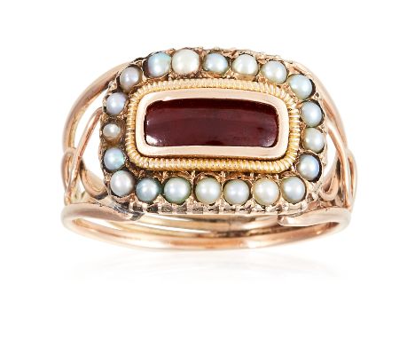 AN ANTIQUE GARNET AND SEED PEARL MOURNING RING, CIRCA 1830 in high carat yellow gold, set with an elongated cabochon garnet e