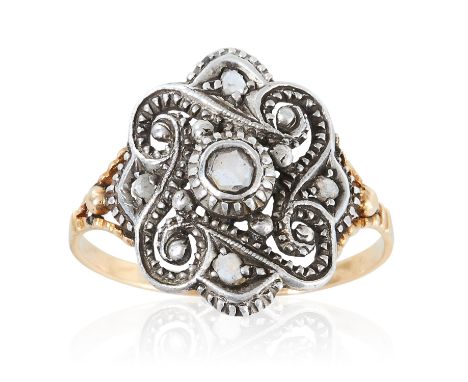 AN ANTIQUE DIAMOND RING, 19TH CENTURY in yellow gold and silver, the central rose cut diamond within a scrolling surround fur