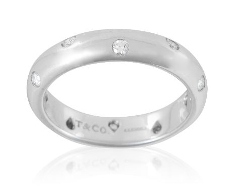 AN ETOILE DIAMOND ETERNITY RING, TIFFANY &amp; CO in platinum, the plain, bevelled band set with ten round cut diamonds, sign