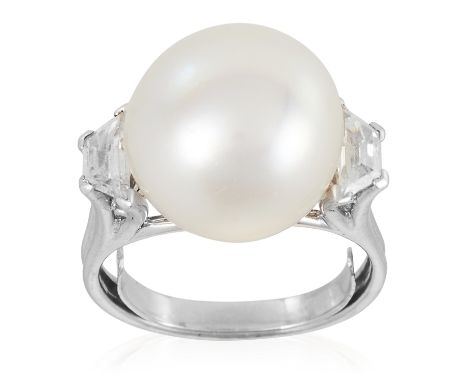 A PEARL AND DIAMOND RING in platinum or white gold, the 12.7mm pearl set between trapezoid cut diamonds, unmarked, size K / 5