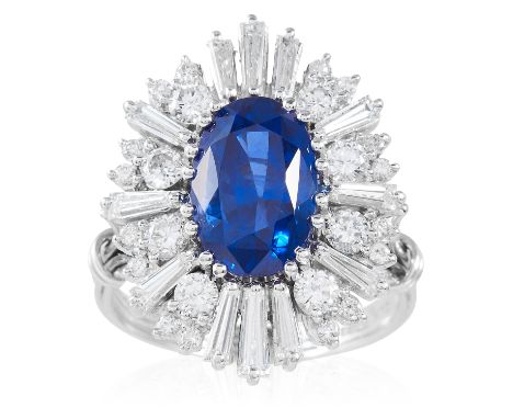 A 4.50 CARAT BURMA NO HEAT SAPPHIRE AND DIAMOND RING in 18ct yellow gold, the 4.50 carat oval cut sapphire encircled by round