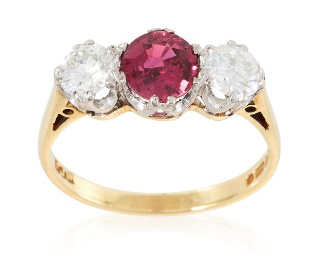 A RUBY AND DIAMOND THREE STONE RING in 18ct yellow gold, the oval cut ruby of 1.28 carats between round cut diamonds totallin