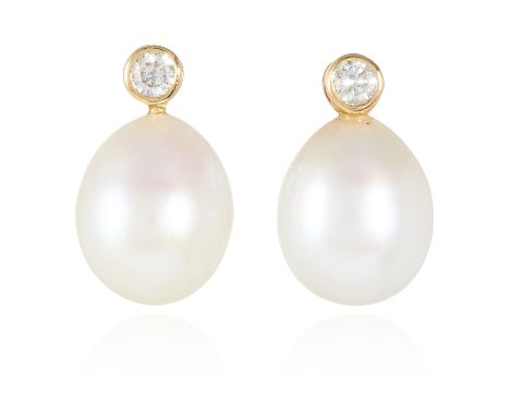 A PAIR OF PEARL AND DIAMOND EARRINGS in yellow gold, each set with a drop shaped pearl below a round cut diamond, unmarked, 1